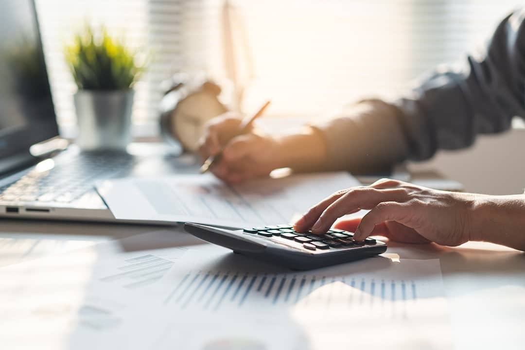 An entrepreneur calculating a business' balances before tax deduction planning.